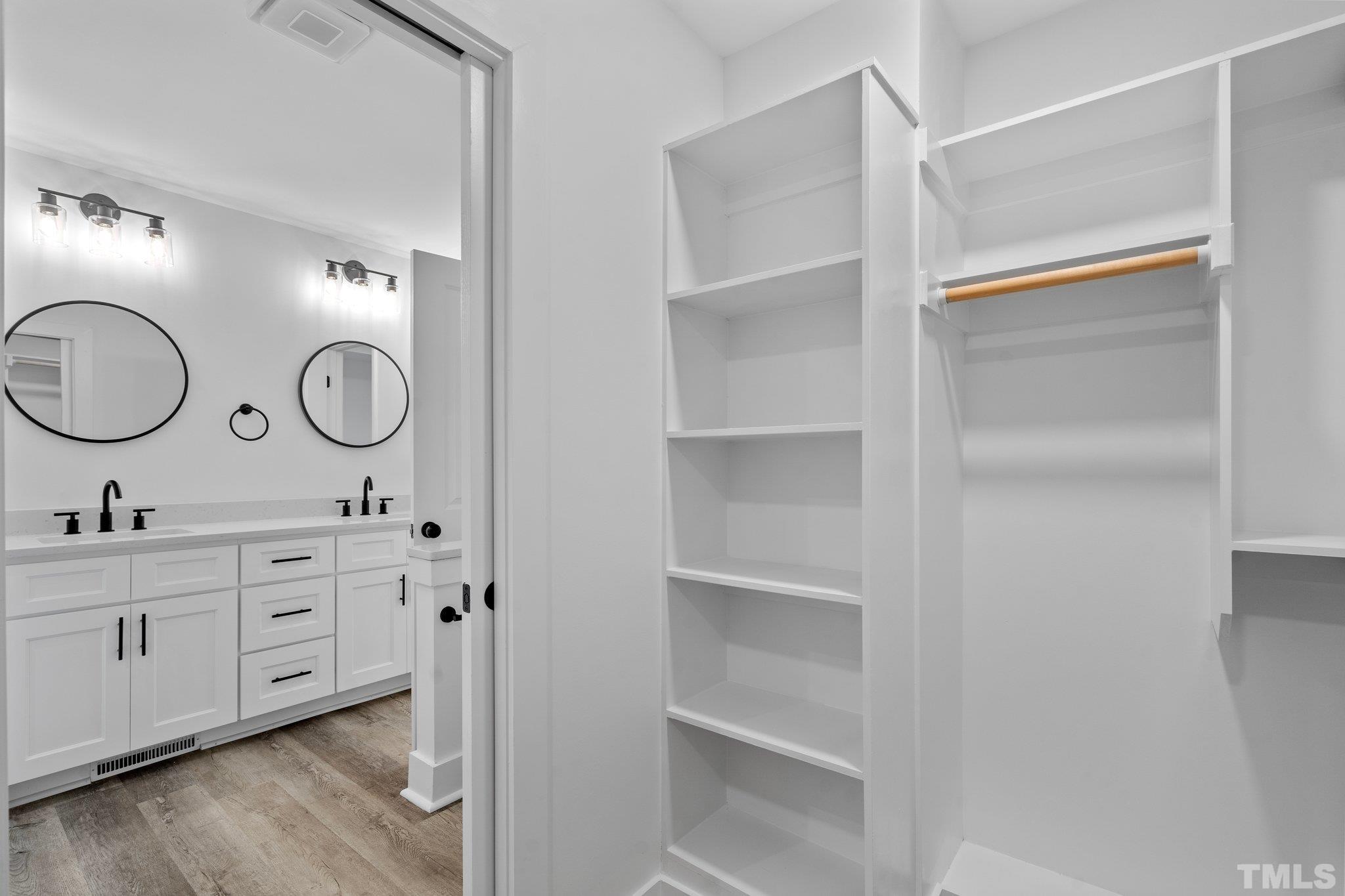 1102 Jerome Road Durham, NC 27713 - Photo 30 of 41 a room with white cabinets and a clock on the wall
