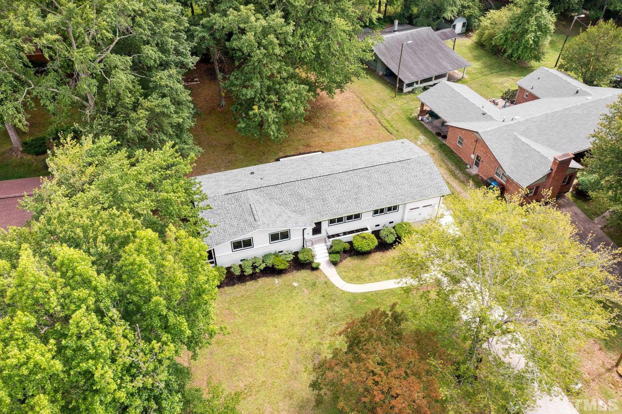 1102 Jerome Road Durham, NC 27713 - Photo 32 of 41 a aerial view of a house with swimming pool and large trees