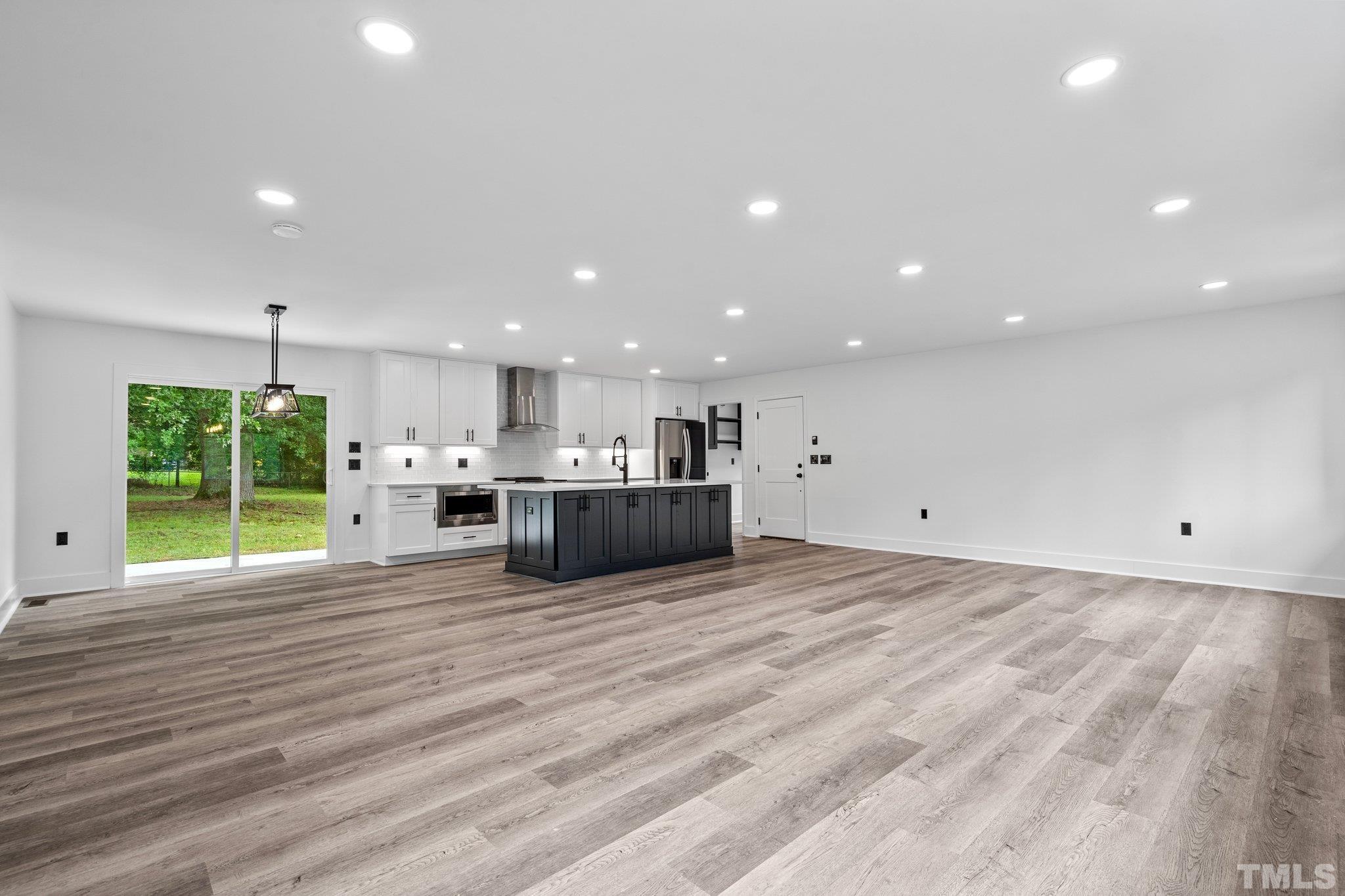 1102 Jerome Road Durham, NC 27713 - Photo 6 of 41 a view of kitchen with kitchen island a sink wooden floor and a refrigerator