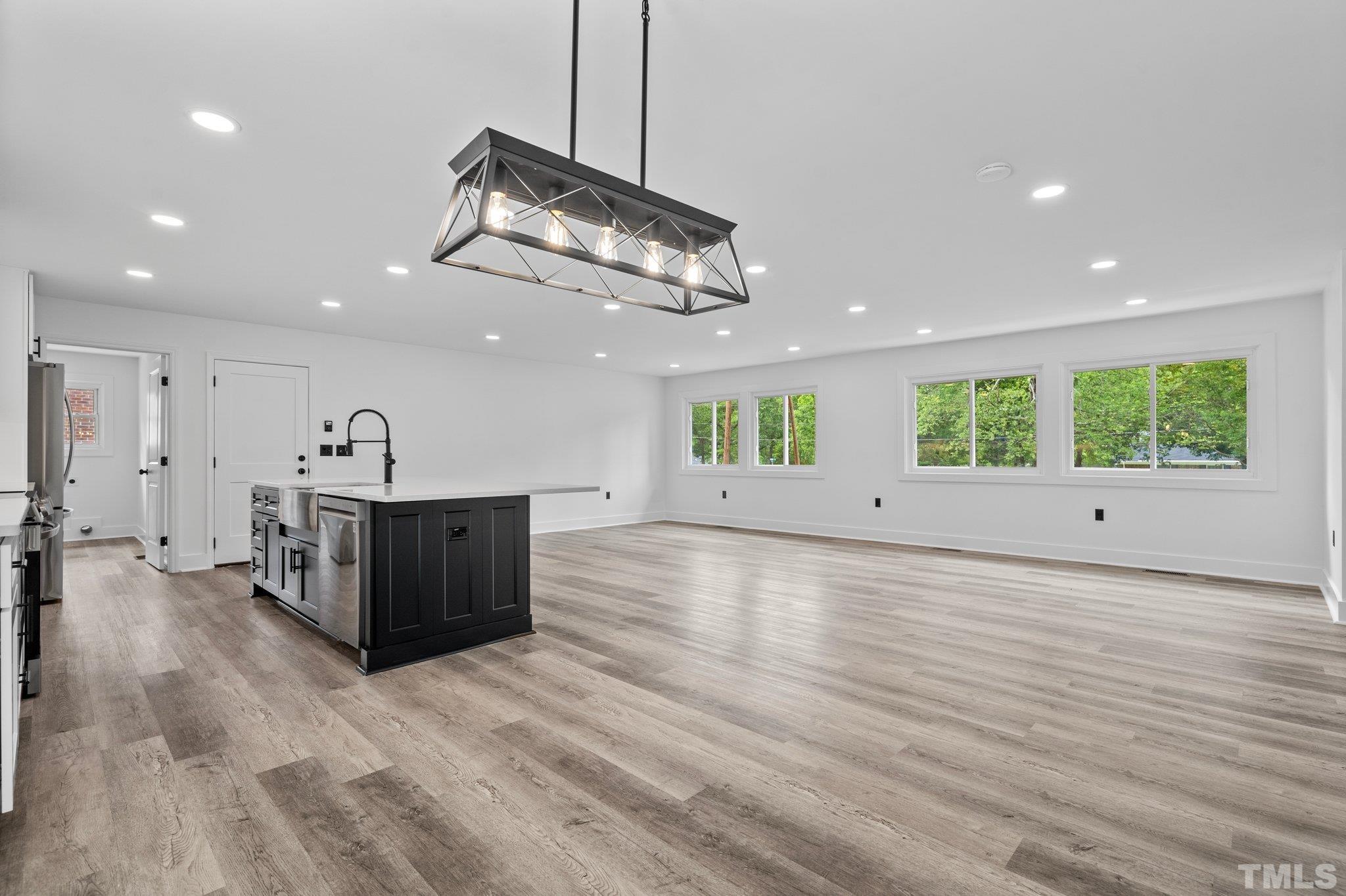 1102 Jerome Road Durham, NC 27713 - Photo 7 of 41 a view of a kitchen with a sink and wooden floor