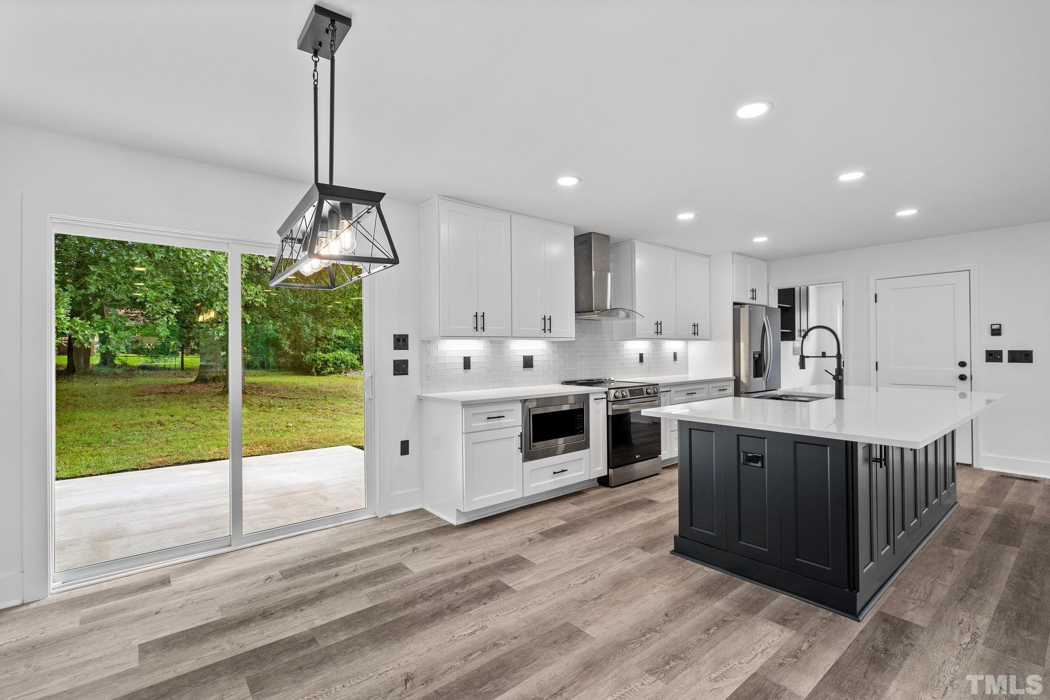 1102 Jerome Road Durham, NC 27713 - Photo 9 of 41 a kitchen with stainless steel appliances granite countertop a sink and cabinets