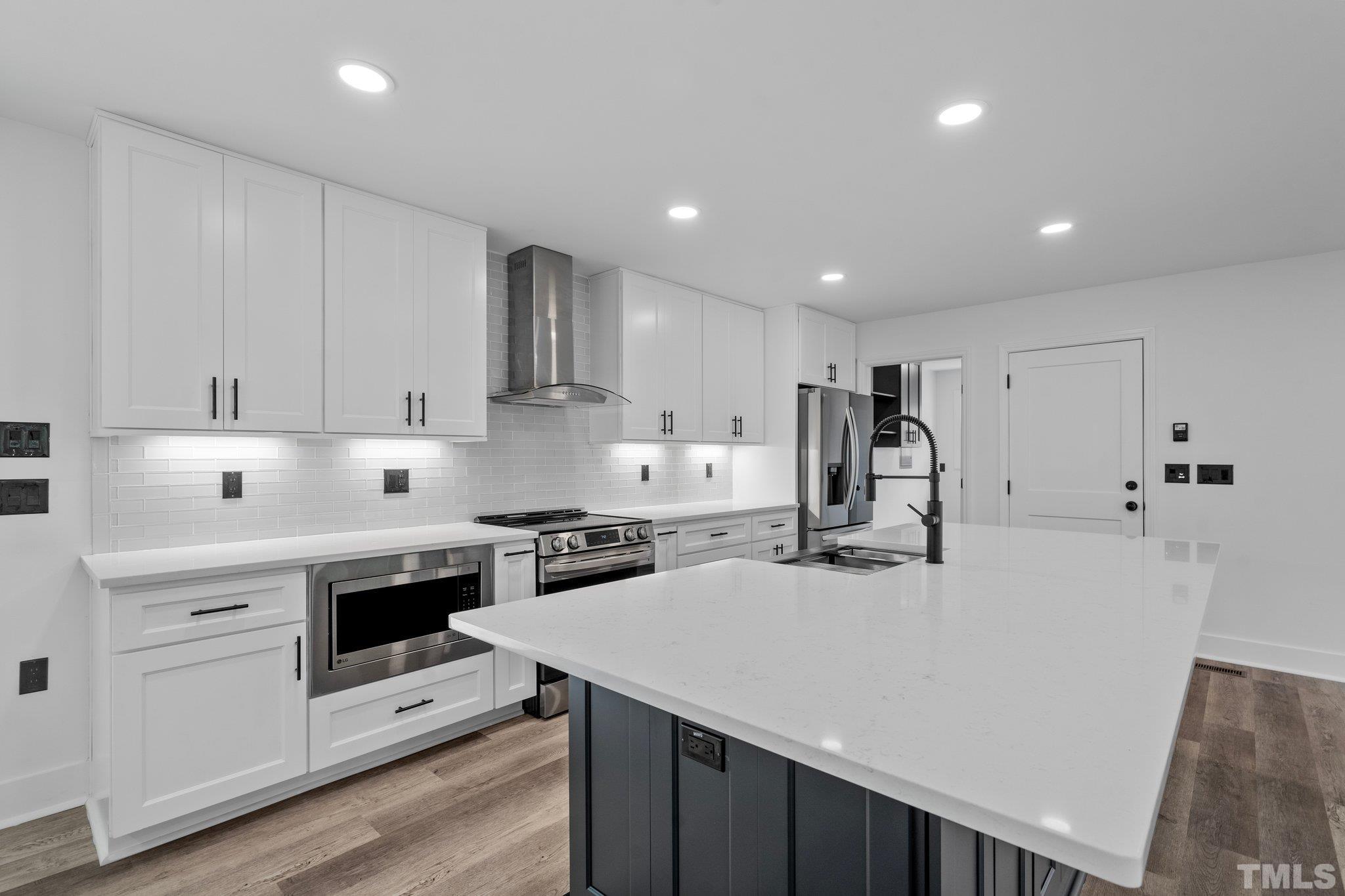 1102 Jerome Road Durham, NC 27713 - Photo 10 of 41 a kitchen that has a lot of cabinets in it and wooden floors