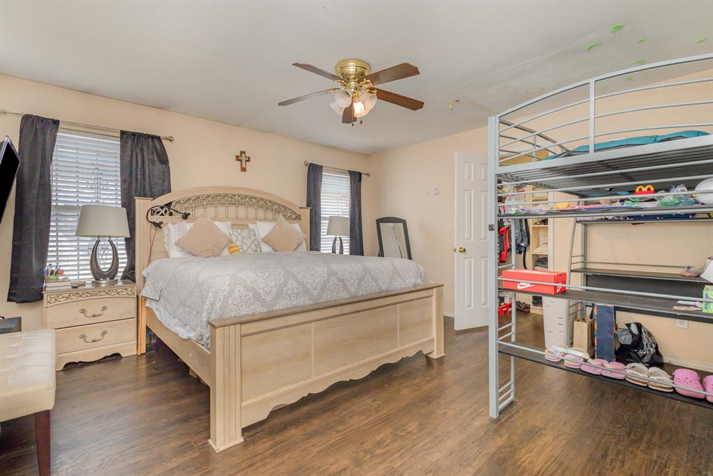 13444 Vida Lane Dallas, TX 75253 - Photo 11 of 17 a bedroom with a bed a flat screen tv and dresser