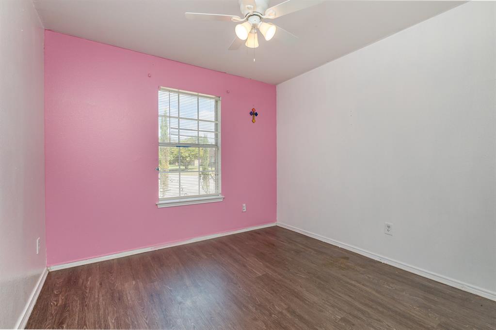 13444 Vida Lane Dallas, TX 75253 - Photo 14 of 17 a view of a livingroom with wooden floor and a ceiling fan