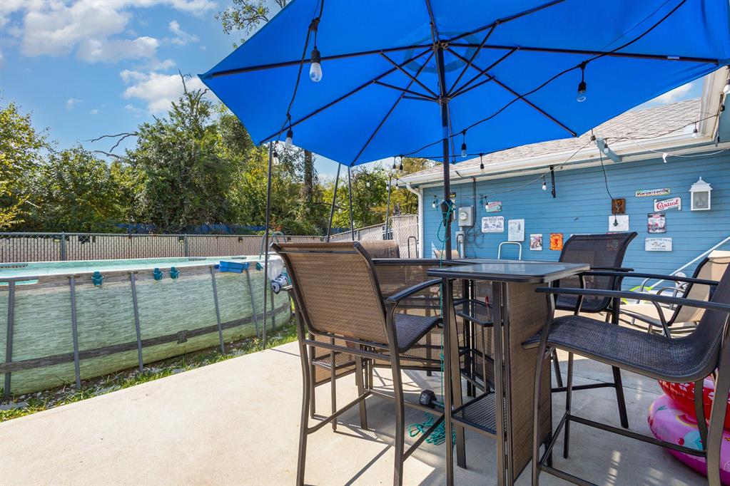13444 Vida Lane Dallas, TX 75253 - Photo 16 of 17 a patio with a table and chairs under an umbrella