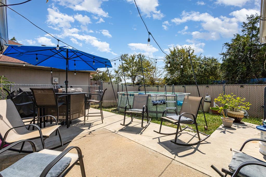 13444 Vida Lane Dallas, TX 75253 - Photo 17 of 17 a view of a patio with chairs under an umbrella