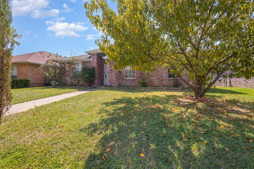 13444 Vida Lane Dallas, TX 75253 - Photo 3 of 17 a view of a yard with a house in the background