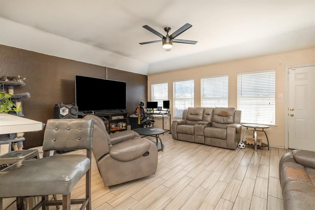 13444 Vida Lane Dallas, TX 75253 - Photo 4 of 17 a living room with furniture and a flat screen tv
