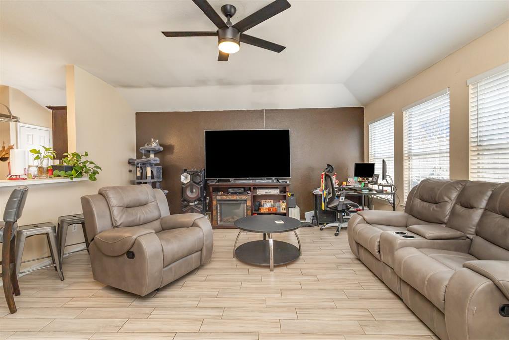 13444 Vida Lane Dallas, TX 75253 - Photo 6 of 17 a living room with furniture and a flat screen tv