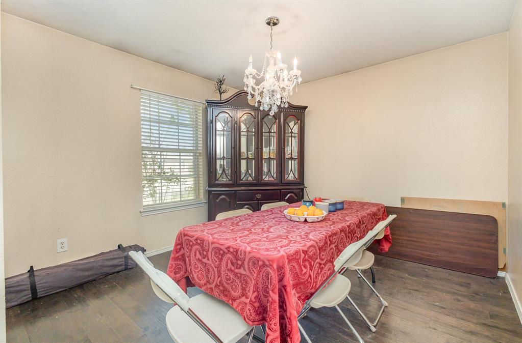 13444 Vida Lane Dallas, TX 75253 - Photo 7 of 17 a dining room with a table chairs and a chandelier