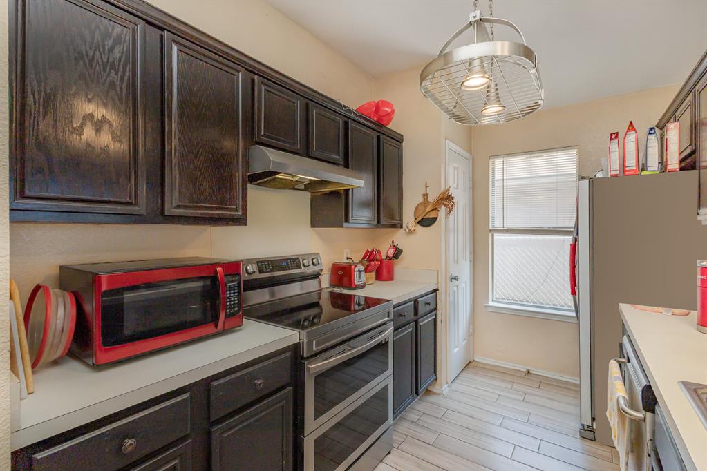 13444 Vida Lane Dallas, TX 75253 - Photo 9 of 17 a kitchen with stainless steel appliances granite countertop a refrigerator and a stove