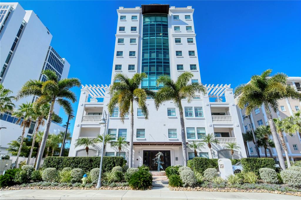 258 Golden Gate Point, Unit 101 Sarasota, FL 34236 - Photo 1 of 1 a front view of multi story residential apartment building with a yard