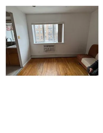 a living room with a bed furniture and a window