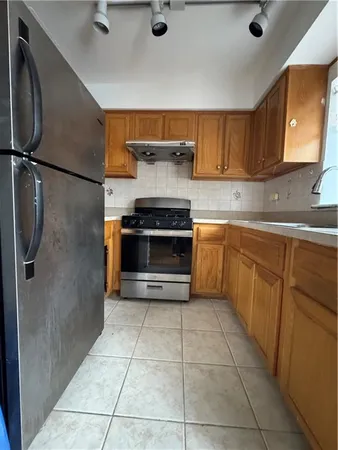 a kitchen with stainless steel appliances granite countertop a stove a refrigerator and a sink