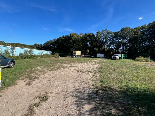 a view of a field with an ocean view