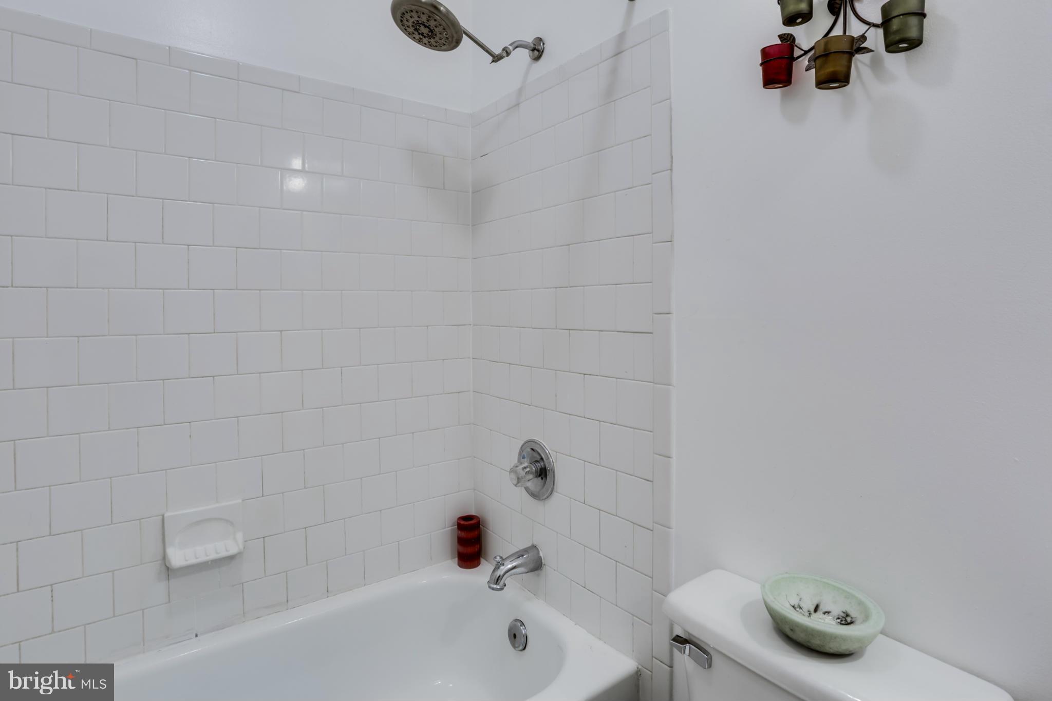 639 Nollmeyer Road Baltimore, MD 21220 - Photo 21 of 28 a bathroom with a tub and a shower