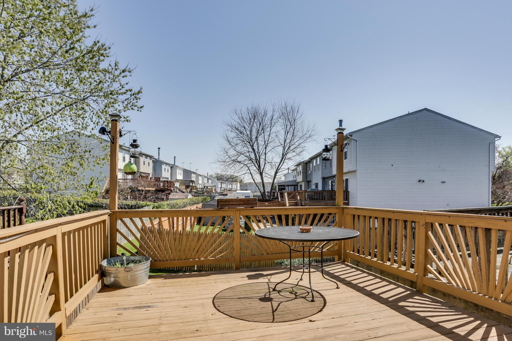 639 Nollmeyer Road Baltimore, MD 21220 - Photo 25 of 28 a view of a roof deck with table and chairs with wooden floor