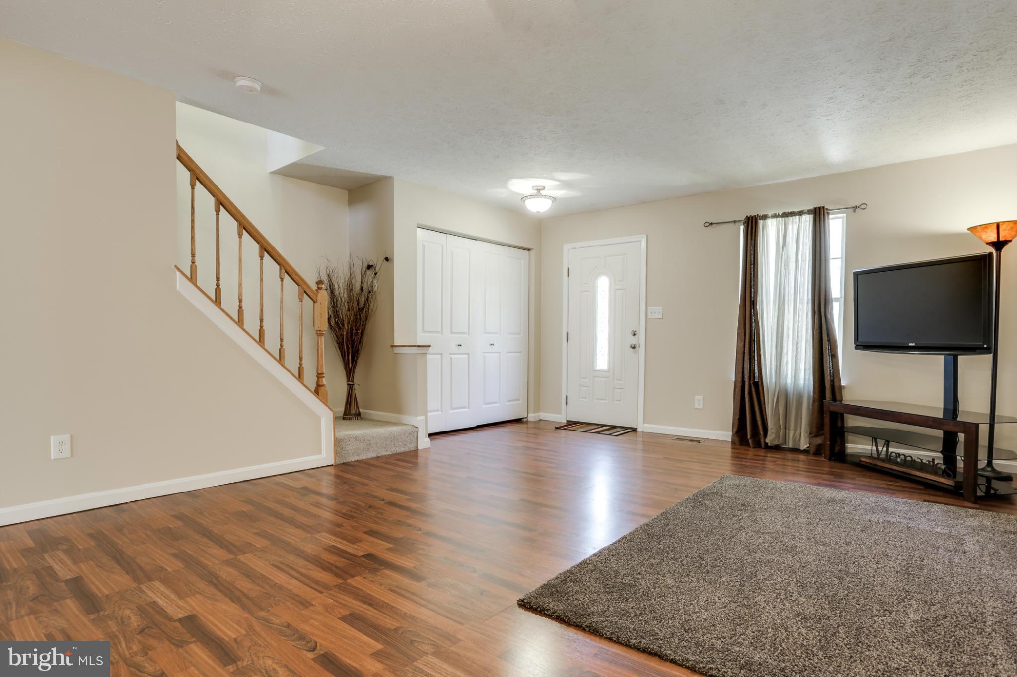 639 Nollmeyer Road Baltimore, MD 21220 - Photo 5 of 28 a view of an empty room with wooden floor and a window