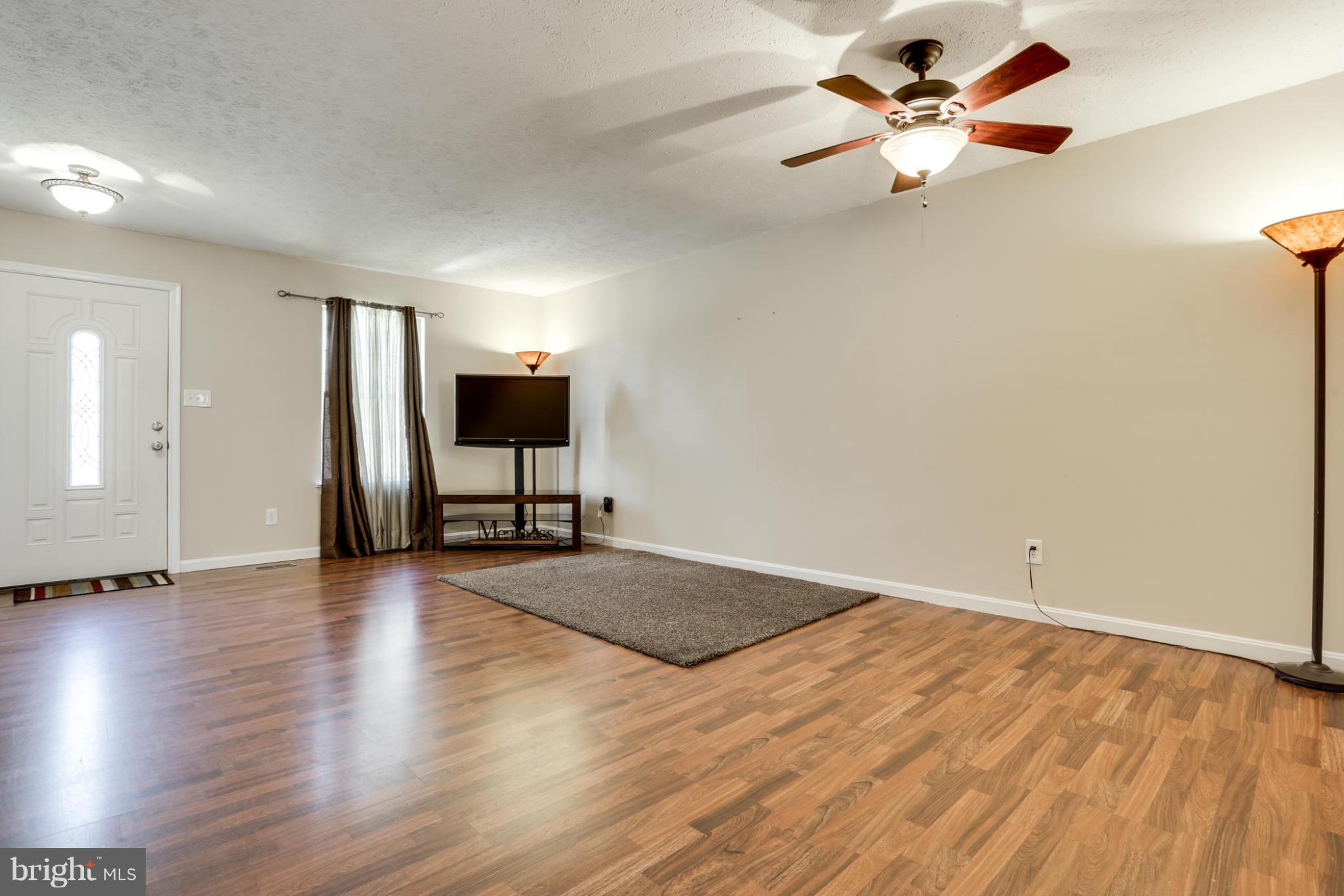 639 Nollmeyer Road Baltimore, MD 21220 - Photo 6 of 28 wooden floor in an empty room with a window