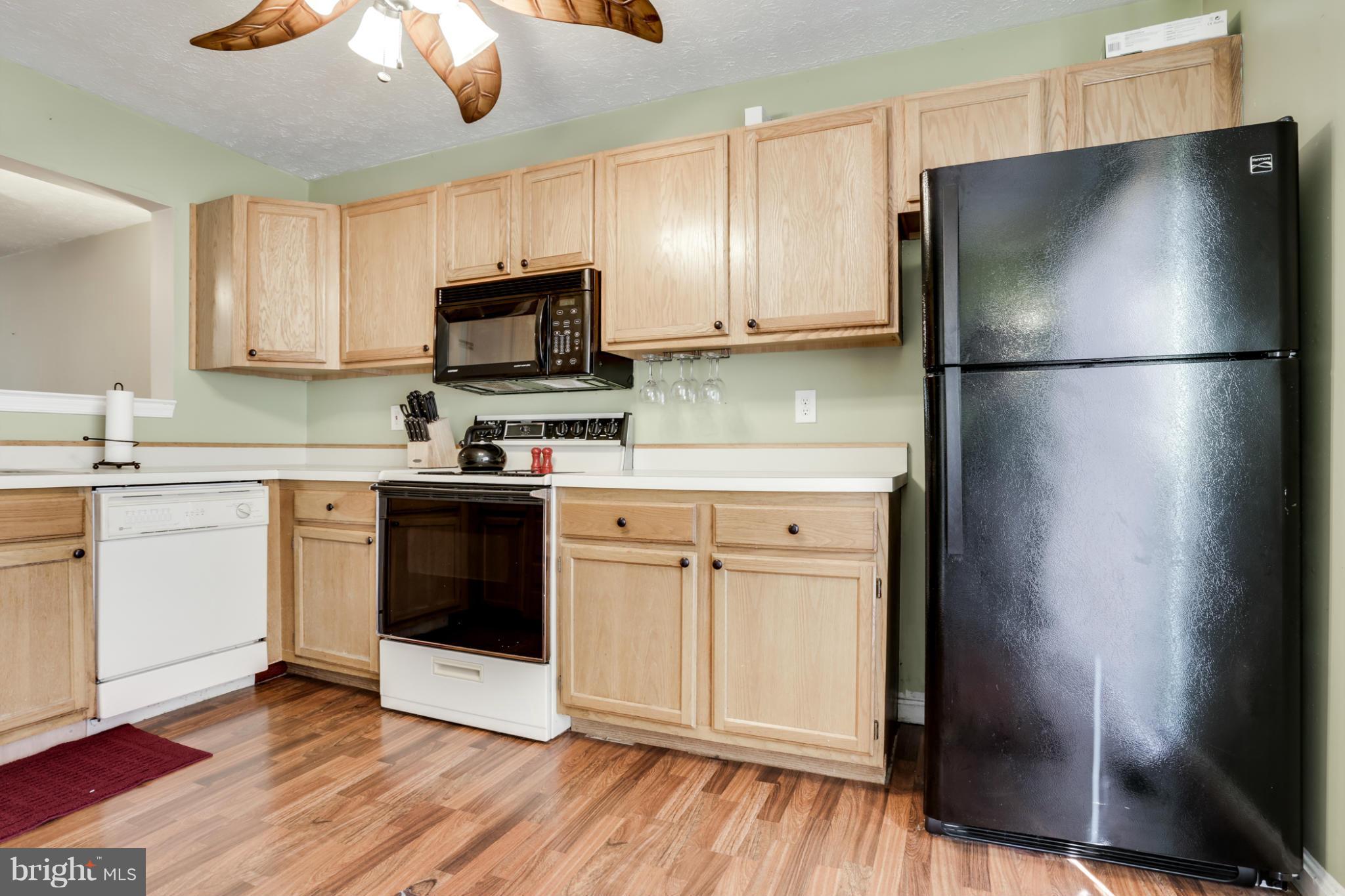 639 Nollmeyer Road Baltimore, MD 21220 - Photo 7 of 28 a kitchen with a refrigerator sink and cabinets