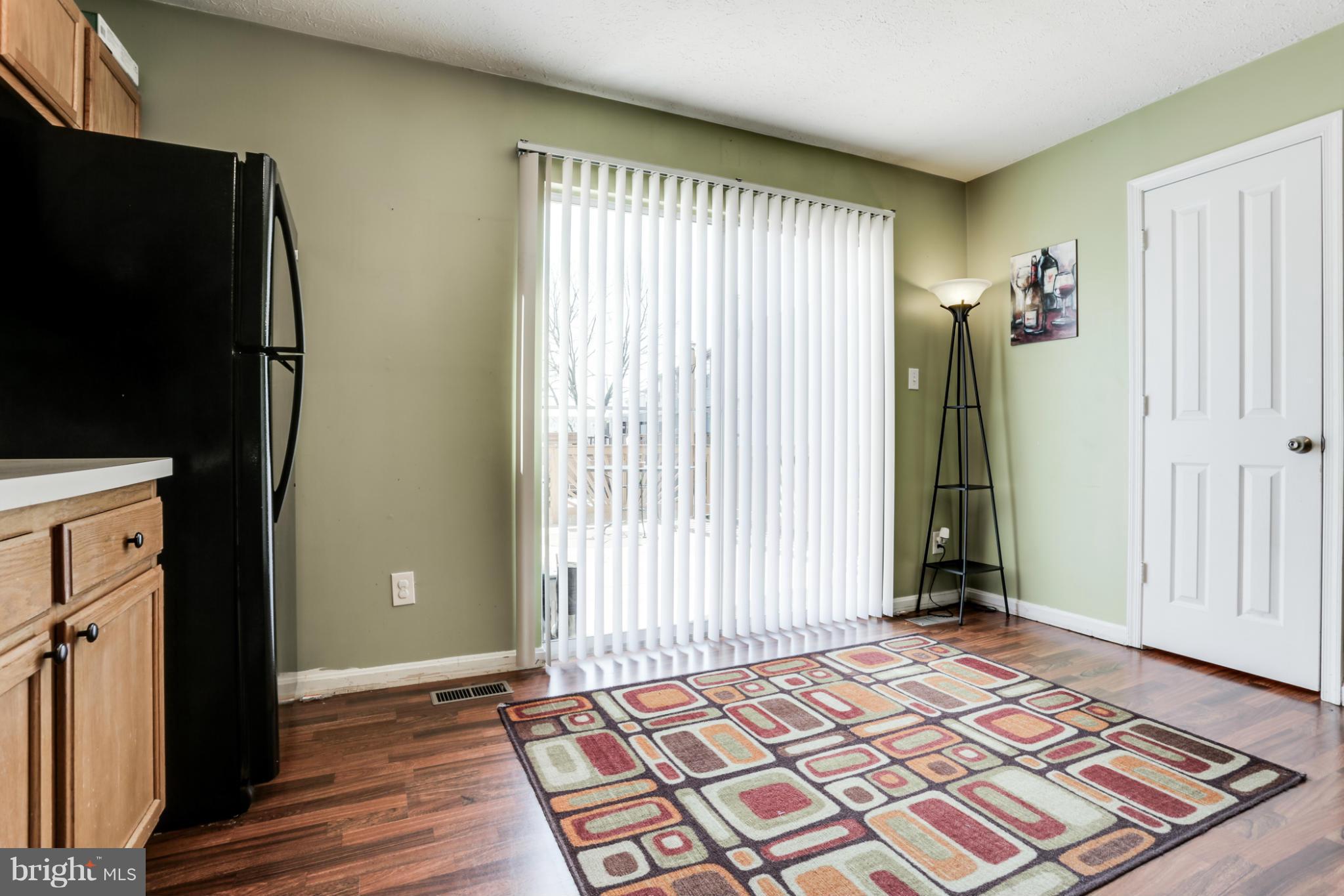 639 Nollmeyer Road Baltimore, MD 21220 - Photo 9 of 28 an empty room with wooden floor and windows