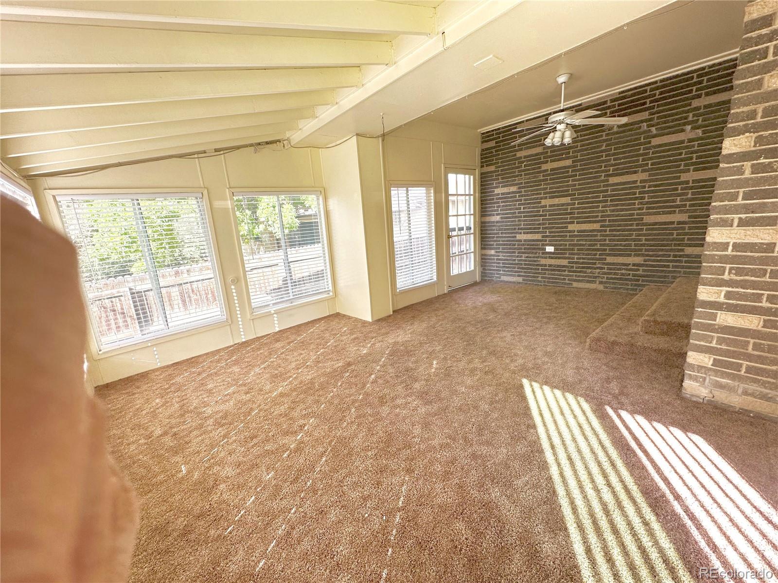 423 Empire Street Aurora, CO 80010 - Photo 13 of 44 a view of empty room with floor to ceiling window