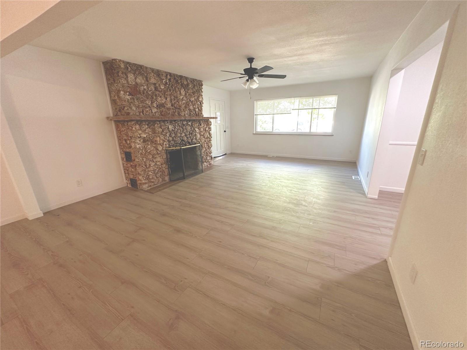 423 Empire Street Aurora, CO 80010 - Photo 17 of 44 an empty room with windows and fireplace