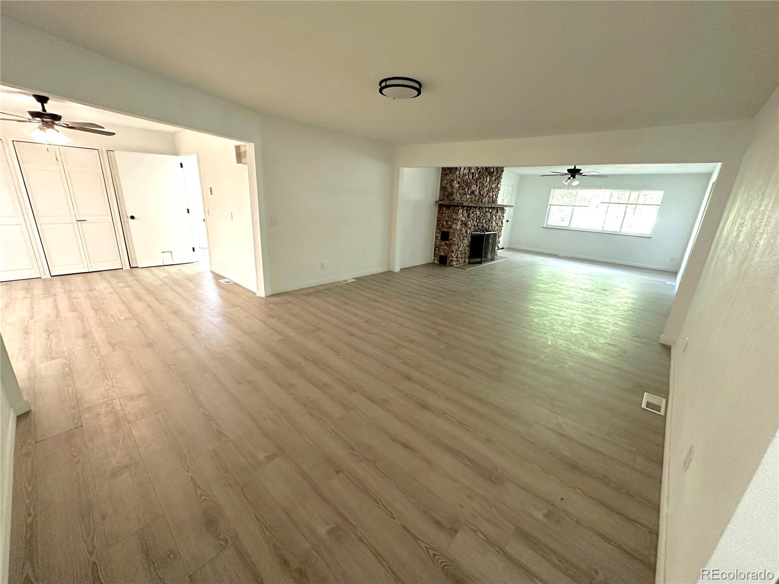 423 Empire Street Aurora, CO 80010 - Photo 20 of 44 a view of empty room with wooden floor