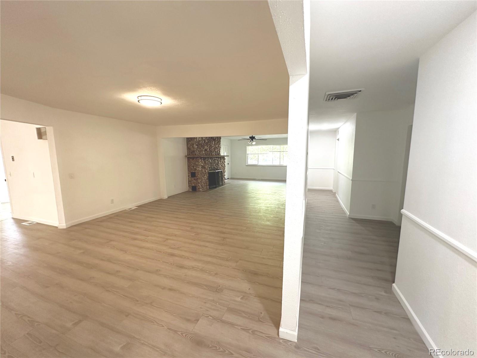423 Empire Street Aurora, CO 80010 - Photo 23 of 44 a view of a hallway with wooden floor
