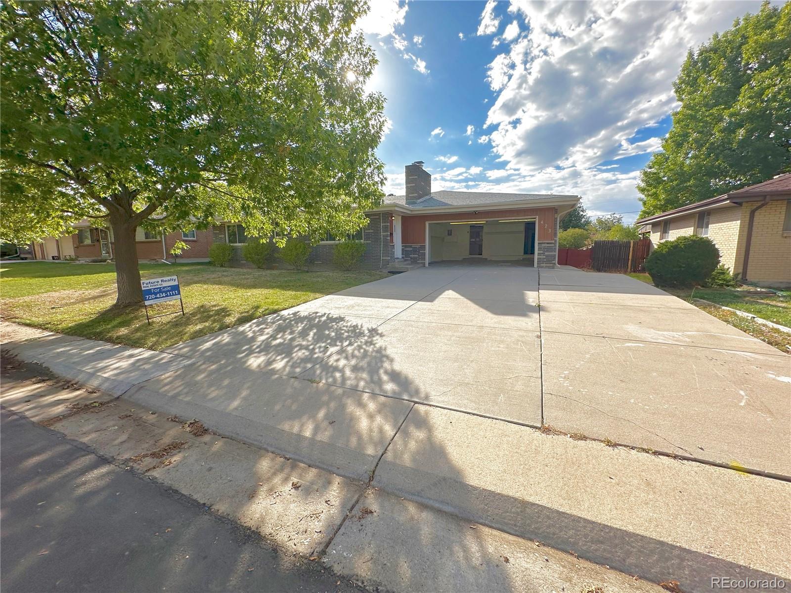 423 Empire Street Aurora, CO 80010 - Photo 3 of 44 a view of a yard with yellow house