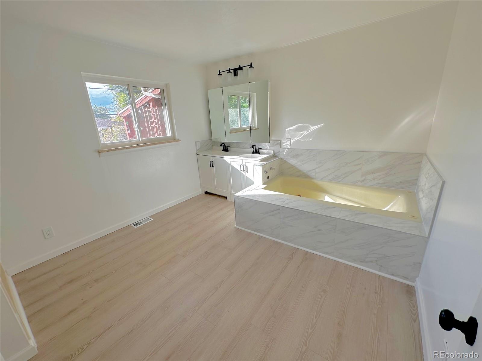 423 Empire Street Aurora, CO 80010 - Photo 36 of 44 a view of empty room with window and fireplace