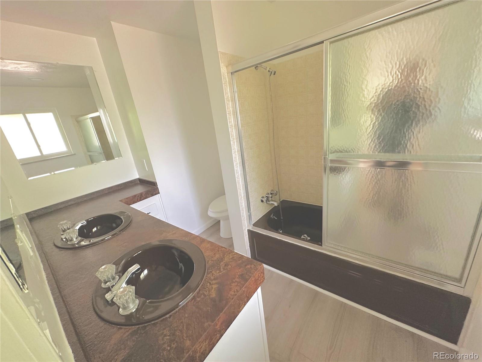 423 Empire Street Aurora, CO 80010 - Photo 38 of 44 a bathroom with a sink and a mirror