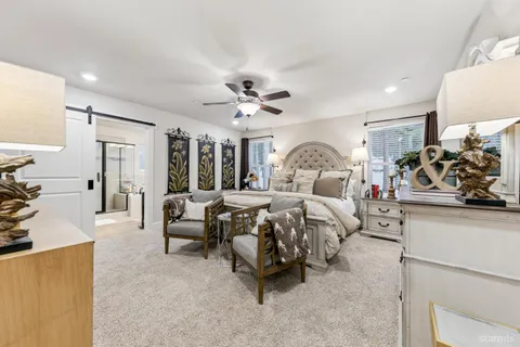 a bedroom with a bed and a chair