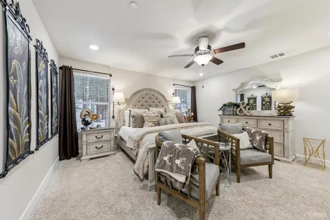 a bedroom with bed and a chandelier