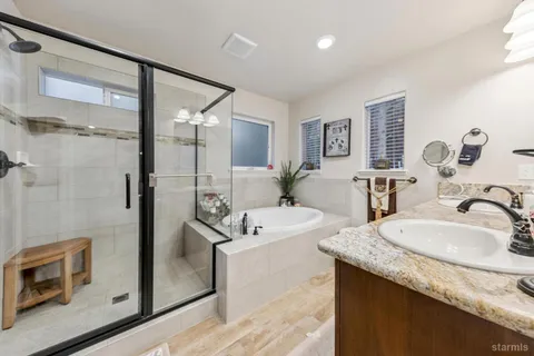 a bathroom with a granite countertop sink mirror and double