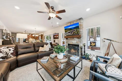 a living room with fireplace furniture and a wooden floor
