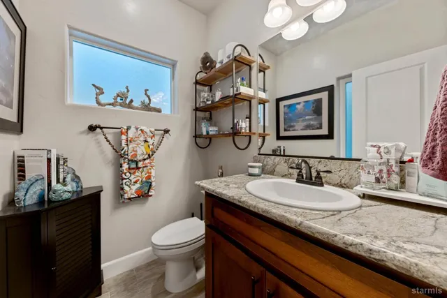 a bathroom with a toilet a sink and mirror