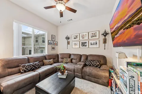a living room with furniture and a large window