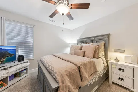 a large bedroom with a bed and furniture
