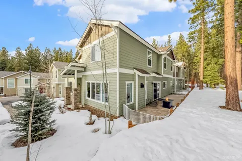 a bathroom with a granite countertop double vanity and a shower