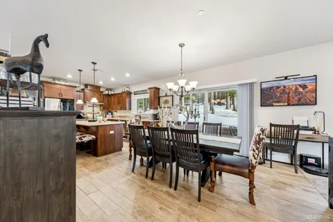 a dining room filled with furniture and wooden floor