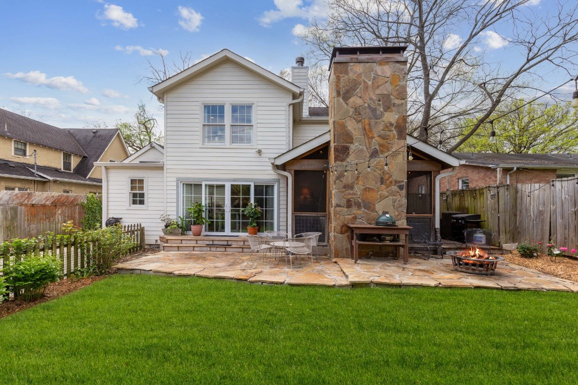 a view of a house with backyard sitting area and garden