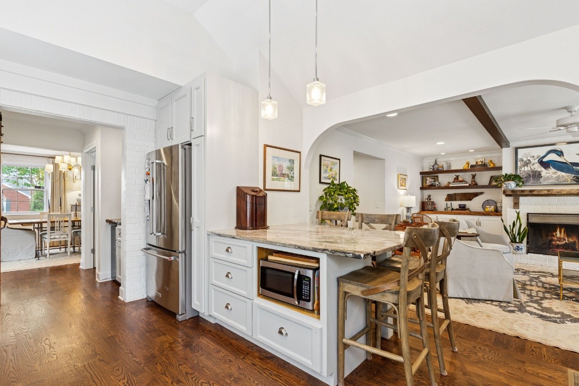 210 Cherokee Road Nashville, TN 37205 - Photo 15 of 56 a kitchen with stainless steel appliances a dining table chairs stove and refrigerator