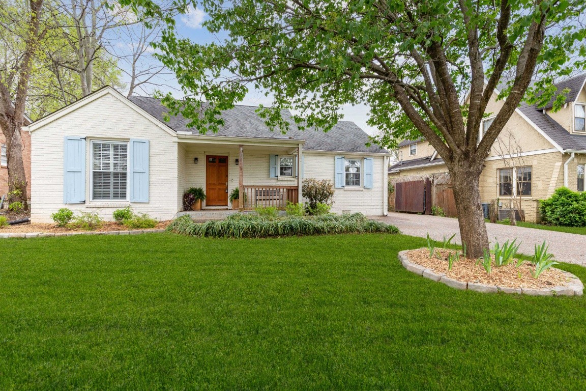 210 Cherokee Road Nashville, TN 37205 - Photo 2 of 56 a front view of a house with a garden and yard