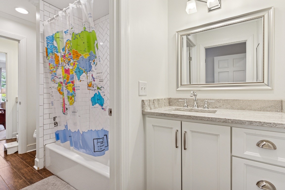 210 Cherokee Road Nashville, TN 37205 - Photo 27 of 56 a en suite bathroom with a granite countertop sink a toilet and a mirror