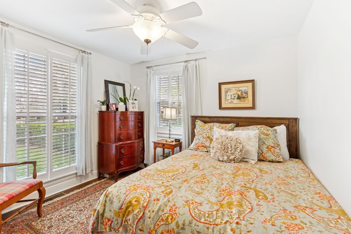 210 Cherokee Road Nashville, TN 37205 - Photo 37 of 56 a bedroom with a large bed and a chandelier