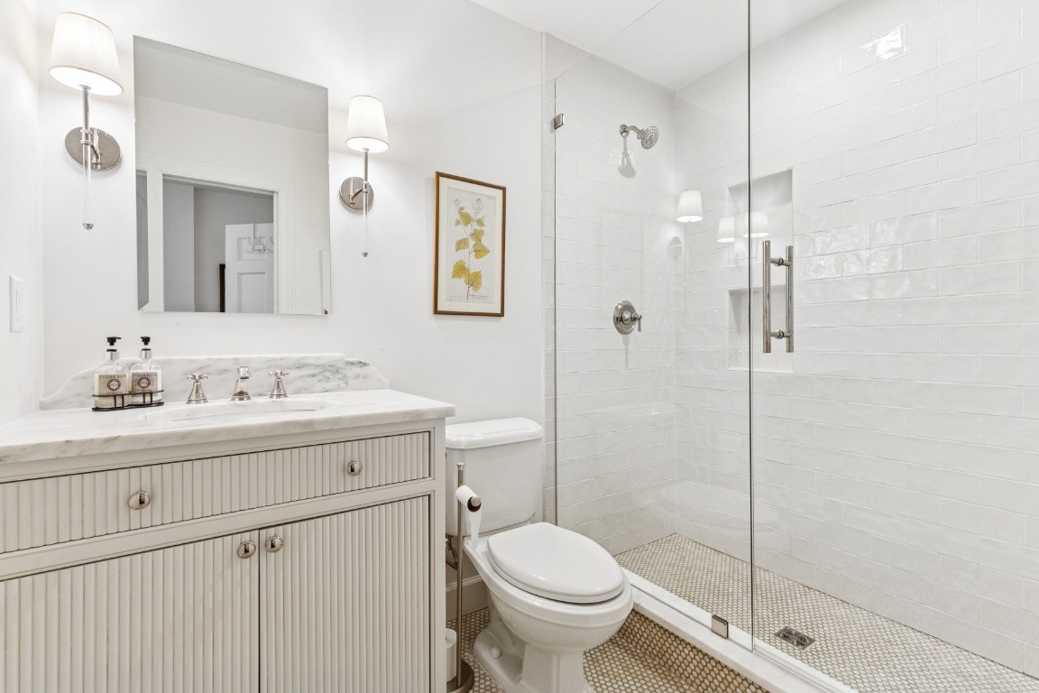 210 Cherokee Road Nashville, TN 37205 - Photo 39 of 56 a bathroom with a shower sink vanity and toilet
