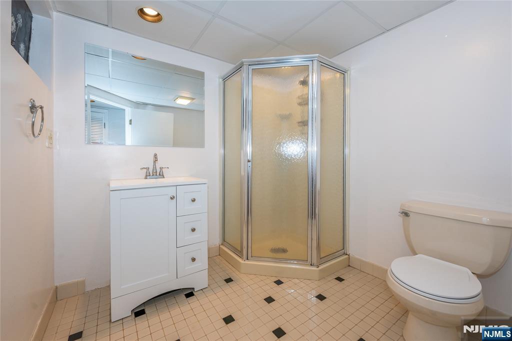 690 Garden Street Maywood, NJ 07607 - Photo 26 of 49 a bathroom with a sink a toilet and shower