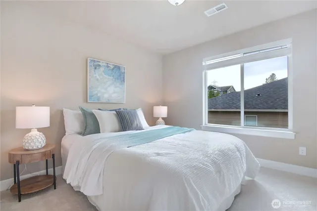 a bedroom with a large bed and a window