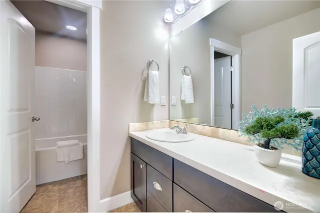 a bathroom with a sink a vanity and a mirror